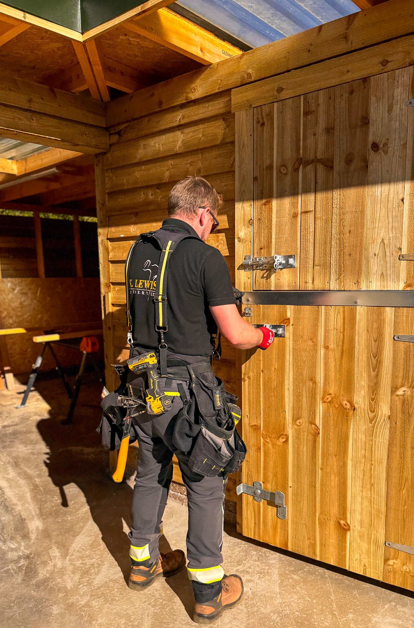 Kris Lewis installing quality hardware on stable door